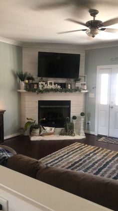 the living room is clean and ready to be used as a tv over the fireplace