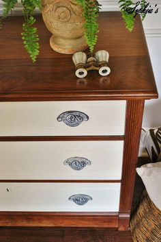 an old dresser has been painted with blue and white stencils on the drawers