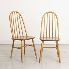 two wooden chairs sitting next to each other