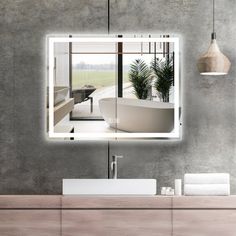 a bathroom with a sink, mirror and bathtub on the wall next to it