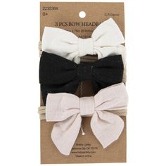 three bow headbands in black, white and grey on the packaging for each child's hair