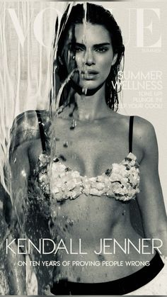 a woman in a bathing suit on the cover of a magazine with water pouring from her face