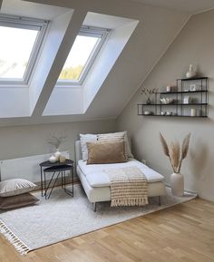 a living room with two skylights and a couch in the middle of the room