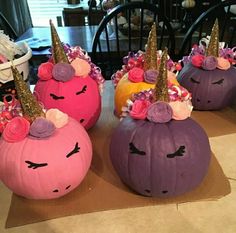 three pumpkins decorated with unicorn ears and flowers