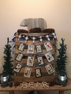 a christmas tree made out of wooden pallets with pictures and pine cones on top