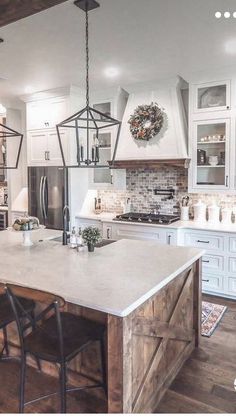 a kitchen with white cabinets and an island