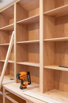 a work bench with tools on it next to shelves