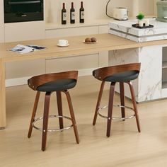 two bar stools sitting in front of a counter