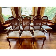 a set of eight chairs in front of a window