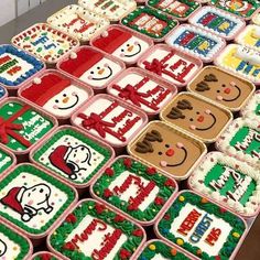 many decorated cookies are arranged on a table with red and green trim around the edges