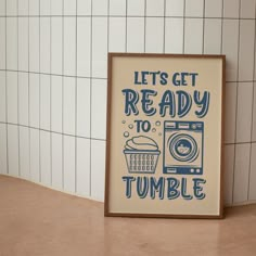 a framed poster that says, let's get ready to tumble with an image of a washing machine