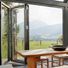 a dining room table with chairs and a bowl on it