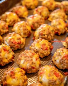 baked meatballs with cheese and tomato sauce on a baking sheet, ready to be eaten