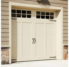 a white garage door with two windows on the side