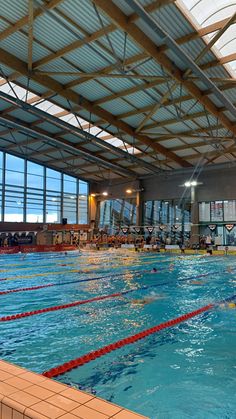 an indoor swimming pool with people in it