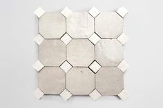 white hexagonal tiles on the wall with no one in them or they can be seen here