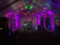 a party tent with purple and green lights