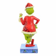 a figurine of a woman dressed as the grinch holding a candy bar