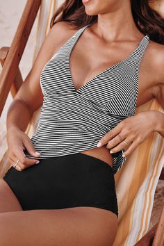 Get ready to shine with the Striped Plunging Tankini Top & Standard Black Bottoms Set! This ensemble combines a boldly striped tankini top with a deep plunge neckline and sleek standard black bottoms. It’s a classic choice for those who prefer a bit more coverage without sacrificing style. Product code: CAA12D4F092AC Features:  Plunging neckline Adjustable straps Standard rise Standard cut leg Classic standard bum coverage Pattern: Stripes Lining: 92%POLYESTER,8%SPANDEX Material: 52%POLYESTER,41 Striped V-neck Swimwear For Beach, Striped V-neck Swimwear For Vacation, Fitted Striped Tankini For Vacation, Striped Sleeveless Tankini For Beach, Striped Halter Top For Beach Season, Black V-neck Halter Top For Beach, Striped Tankini For Poolside, Striped Fitted Sleeveless Tankini, Chic V-neck Tankini For Beach Season