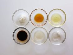 four different types of sauces in glass bowls