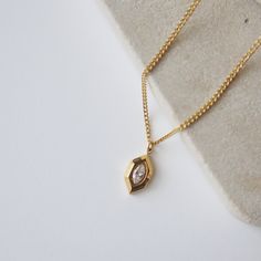 Introducing our Marlow Necklace, a testament to timeless elegance and refined minimalism. The marquise shape gracefully frames a CZ stone, adding a touch of sparkle and radiance. Its minimalistic style makes it perfect for any occasion. -stainless steel, gold plated -15.5" with 2" extender Gold Marquise Cut Necklace For Gift, Timeless Gold Necklace With Marquise Shape, Timeless Gold Marquise Necklace, Timeless Marquise Gold Necklace, Gold Necklace With Single Marquise Cut Diamond, Gold Necklace With Marquise Cut Diamond, Gold Marquise Cut Necklace With Single Diamond, Modern Gold Marquise Cut Jewelry, Modern Marquise Cut Gold Jewelry