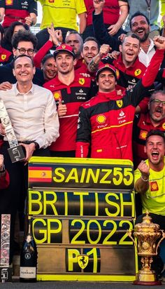 a group of men standing next to each other in front of a trophy