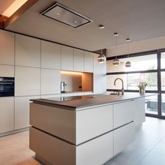 a modern kitchen with an island in the middle