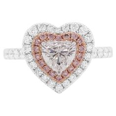 Celebrate love with our Valentine Special Heart Shape White and Pink Diamond Ring. This exquisite piece is a symbol of eternal commitment, featuring a heart-shaped white diamond encircled by delicate Argyle pink diamonds. Crafted with precision and passion, it's a perfect expression of love for this romantic season. GIA-certified Heart Shape White Diamond- 0.50 CT Argyle Pink Diamonds-0.09 CT White Diamonds- 0.42 CT Made in K18 White/Pink Gold HYT Jewelry is a privately owned company headquarter Pink Gold Rings, Argyle Pink Diamonds, Pink Diamond Ring, Modern Engagement Rings, Contemporary Ring, Heart Shaped Rings, Colombian Emeralds, 18k Gold Ring, Valentine Special