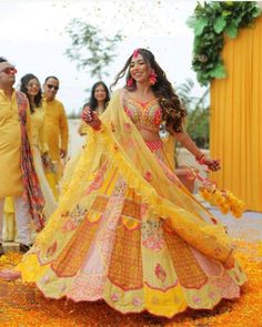 the bride and groom are dressed in bright yellow outfits