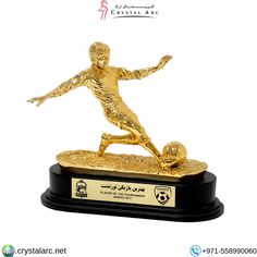 a gold trophy with a soccer player on it's base and the name crystalare