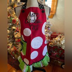 an apron on display in front of a christmas tree