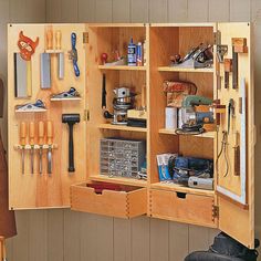 an open cabinet with tools in it