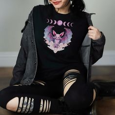 Embrace your unique style with this Pastel Goth Bat Shirt featuring intricate moon phases design. Perfect for fans of Yami Kawaii, Fairy Kei, and Pastel Grunge fashion, this Pink Kawaii Shirt is a must-have addition to your wardrobe. Made for those who love Vaporwave Clothing and Harajuku Kawaii vibes, this shirt combines edgy elements with pastel colors to create a one-of-a-kind look. Stand out from the crowd and express your individuality with this trendy and versatile piece! SIZE CHART:  - Pl Pastel Grunge Fashion, Vaporwave Clothing, Kawaii Shirt, Kawaii Fairy, Bat Shirt, Kawaii Shirts, Pink Kawaii, Grunge Shirt, Pastel Grunge