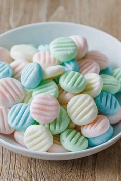 a white bowl filled with pastely colored candy