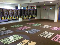 the room has many signs on the floor for people to sign in front of them