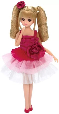 a doll with blonde hair wearing a pink dress and flower in it's hair