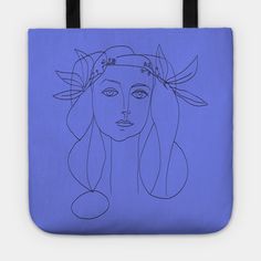 a blue tote bag with a drawing of a woman's face on it