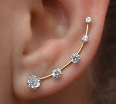 This gorgeous Earring Pin has five graduated prong set Cubic Zirconias, and simulates the look of multiple piercings. Only one piercing is needed, and it can be worn in virtually any hole on the ear up or down. This earring pin is shaped like a bobby pin, with a wire that goes up the back of the ear to hold the piece in place comfortably and securely. We use only the highest quality materials, 14K Gold Filled and Sterling Silver. This piece will arrive in a Gift Box and include simple fitting in Ear Pin, Ear Crawler, Earring Pins, Ear Crawlers, Ear Climber, Ear Pins, Ear Earrings, Ear Climbers, Ooh La La