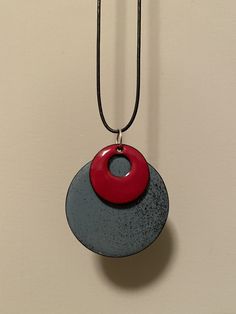 a black and red necklace hanging on a wall