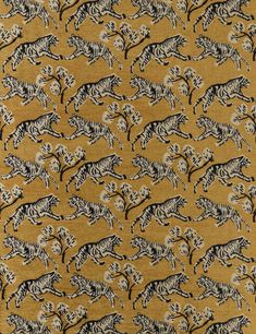 an animal print fabric with black and white zebras on gold background, close up