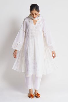 White kurta with embroidered motifs. Comes with inner slip, pant and dupatta.
Components: 4
Fabric: Mul Mul, Hakoba
Neckline: Kurta: Notched round; Inner: Scoop
Sleeve Length: Kurta: Full; Inner: Sleeveless
Color: White
Embroidery
Aari embroidery
Flared sleeves on kurta
Fringe detail on kurta hem
Scallop hem on pant - Aza Fashions Cotton Saree Blouse Designs, Kurti Patterns, White Kurta, Women Kurta, Kurta Designs Women, Blouse Models, Ageless Style, Straight Kurta, Dress Indian Style