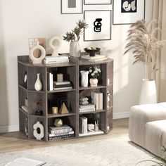 a living room filled with furniture and pictures on the wall