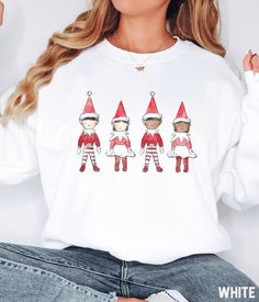 Our Christmas Elf graphic sweatshirt features a vintage inspired watercolor elfs design. You'll love the comfortable material of the Gildan sweatshirt fabric. It ensures a soft and comfortable feel that will keep you feeling good all day long. This unisex trendy and aesthetic graphic sweatshirt and hoodie will have you standing out from the crowd. Christmas Elf Sweatshirt, Merry Christmas Crewneck For Women, Oversized Cute Christmas Hoodie, Watercolor Elves Shirt, Christmas Elf Sweater SIZE UP f Elf Sweatshirt, Elf Sweater, Elf Shirt, Gildan Sweatshirt, Retro Graphic Tees, Christmas Crewneck, Christmas Hoodie, Cute Graphic Tees, Holiday Sparkle