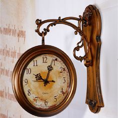 an old fashioned clock hanging on the wall