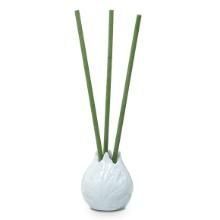 a white vase with three green stems in it