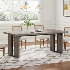 a dining room table with chairs and a rug on the floor in front of it