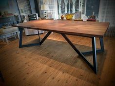 a wooden table sitting on top of a hard wood floor