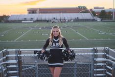 a cheerleader standing on the bleachers with her pom - poms