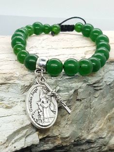 Jade Rosary bracelet with your choice of Catholic saint and crucifix.   Photo shows Guardian Angel medal. Bracelet is natural Jade and will have some natural variation in colour. The photos on my listing are a good representation of the quality of the Jade. Adjustable bracelet with square knot closure. Saint medallion and crucifix are made in Italy. Your choice of saint plus the corpus crucifix.  The charms will be soldered on to your bracelet so they won't be lost.  All knots are secured.  Plea Adjustable Green Spiritual Rosary Bracelet, Adjustable Crucifix Spiritual Bracelet, Catholic Saint, Square Knot, Rosary Bracelet, Natural Jade, Custom Bracelets, Guardian Angel, Adjustable Bracelet