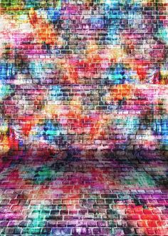 an abstract brick wall with multicolored paint streaks on it's walls and floor